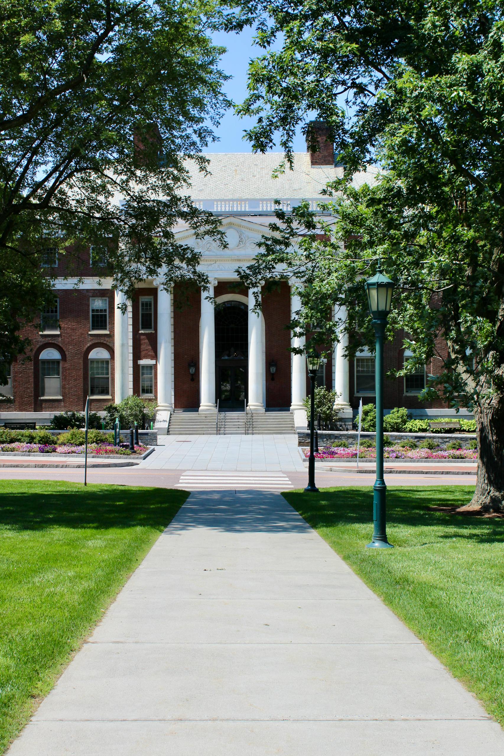 Majestic red brick university building with columns in Burlington, VT.